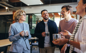 A picture of an office coffee station with employees socialising