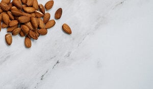 Photograph of almonds spread on a countertop 