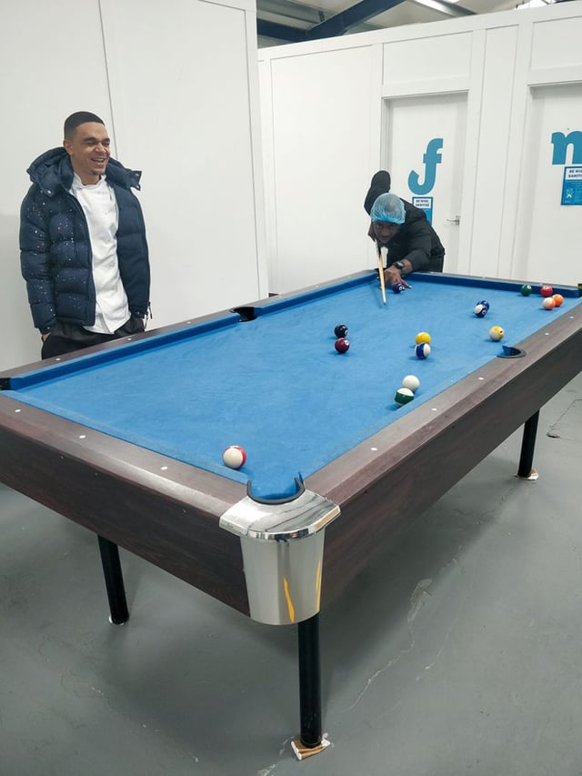 Fooditude contract catering chefs relaxing and playing pool.