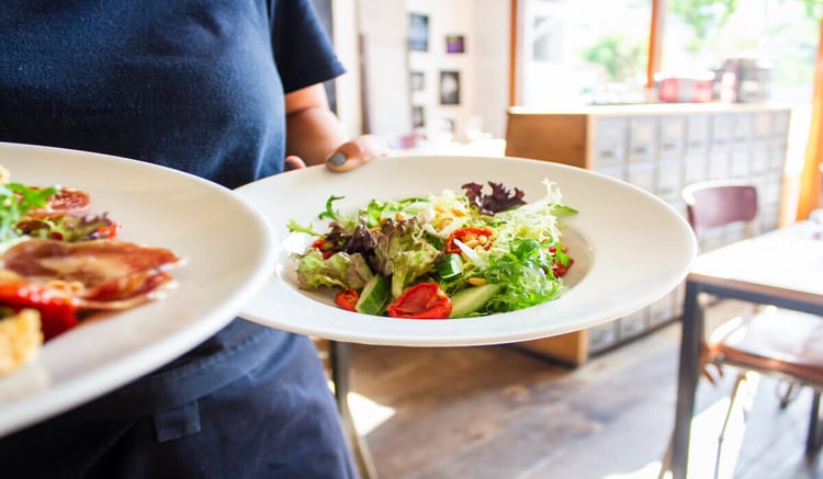 employee with a plate of buffet food for lunch provided by a contract caterer