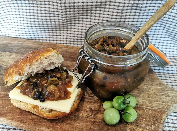 Jar of Green tomato chutney with a chutney sandwich on the side