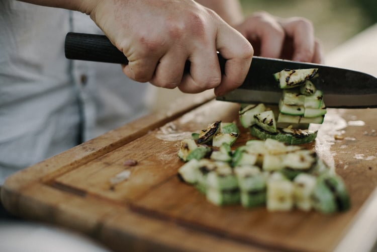 Chef at a corporate catering company cutting vegetables