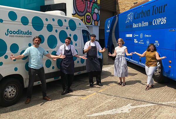 Fooditude employees in front of vans