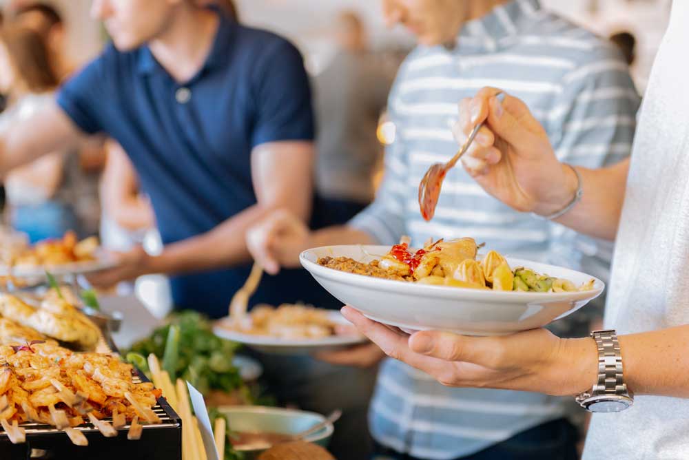 A person holding a bowl of food