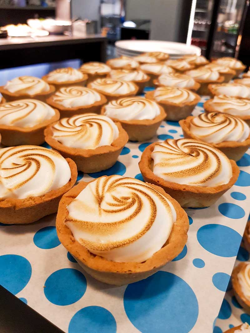 A tray of mini lemon meringues 