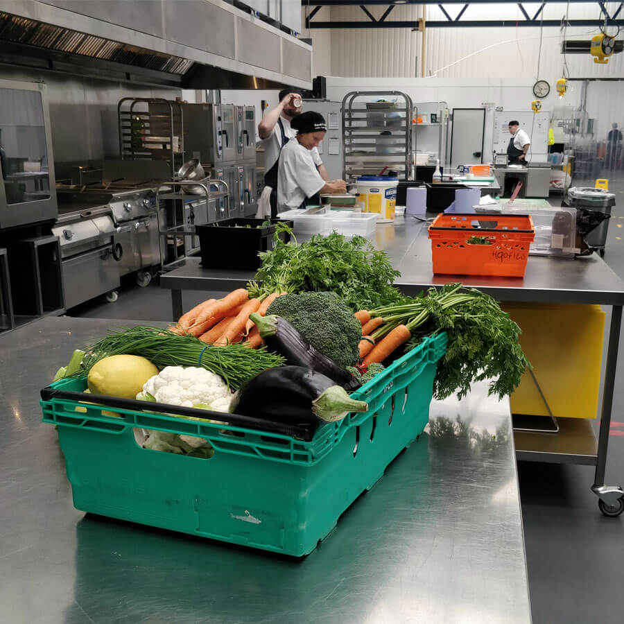 A box of vegetables in the kitchen